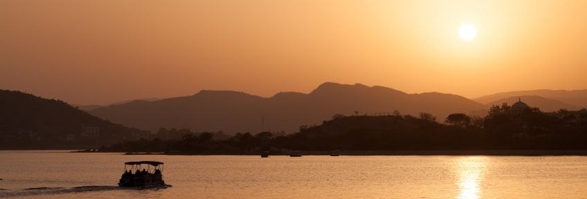 A golden-brown sunset over Lake Pichola