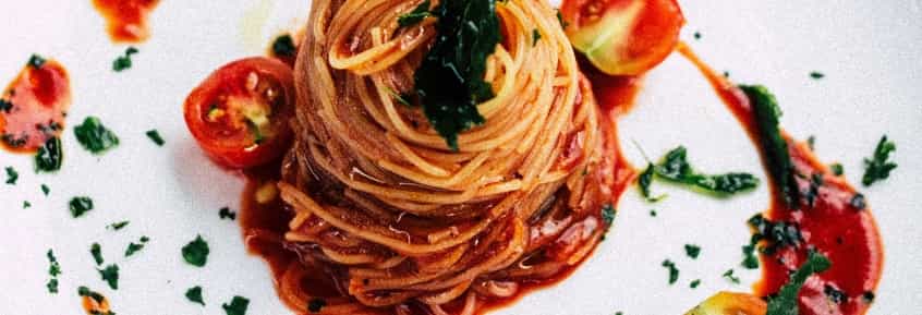 Italian spaghetti with tomato sauce in a white plate