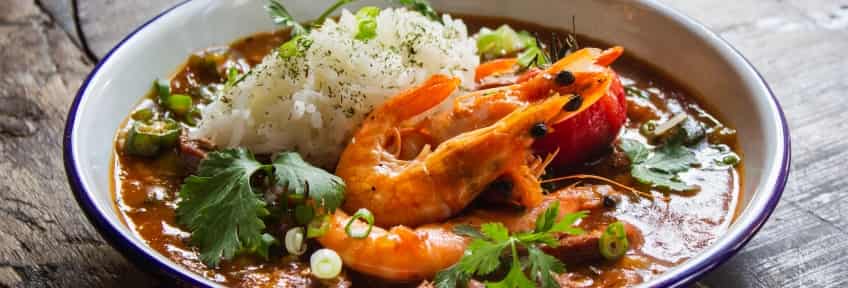 A plate of Gumbo with shrimps and rice