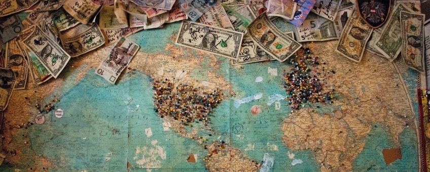 Currency of different countries laying on the world map