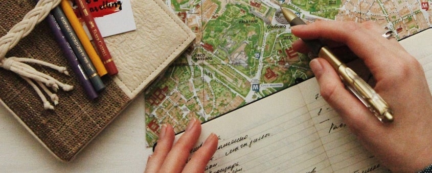 A person noting down all the steps to undertake to start a travel agency